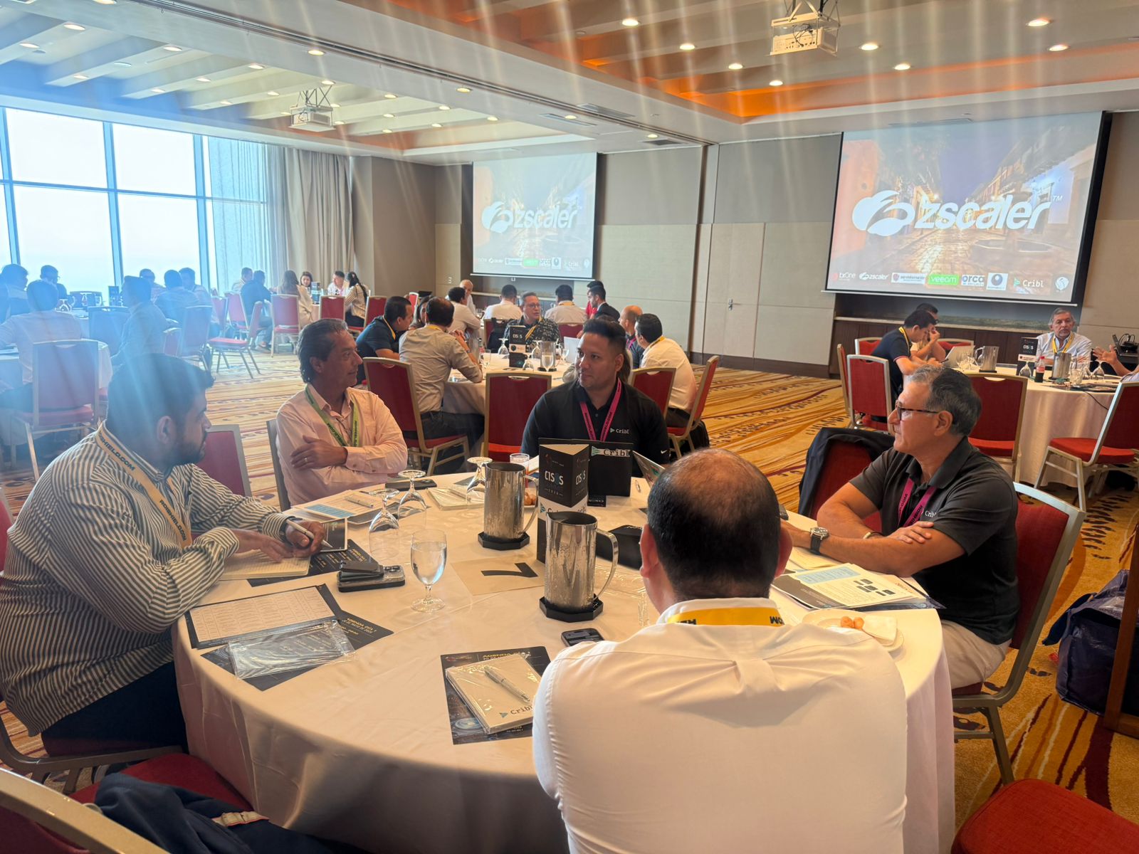 CISOs and security leaders engaged in deep table discussions overlooking the Caribbean sea